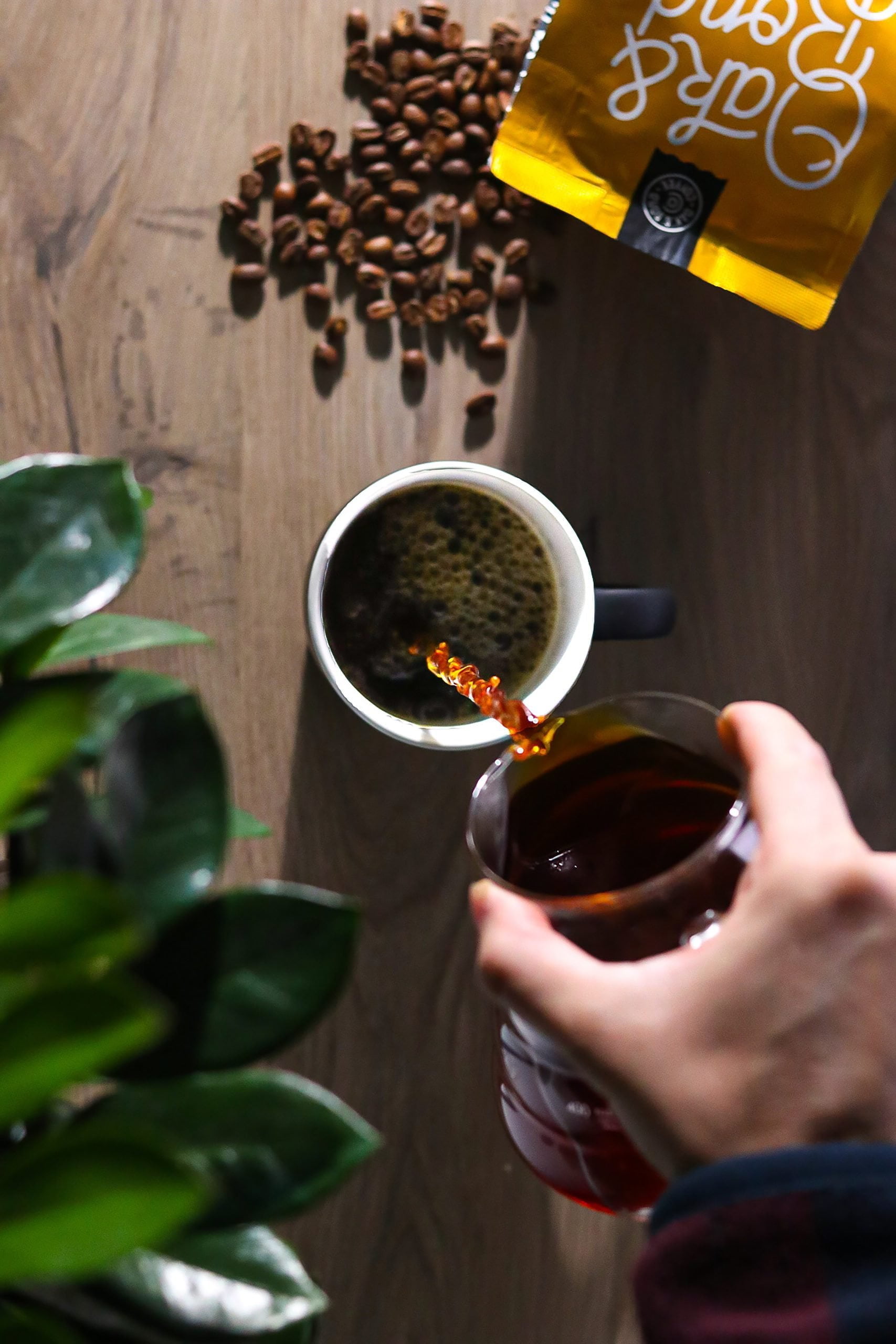 a person pours specialty single origin coffee into a cup