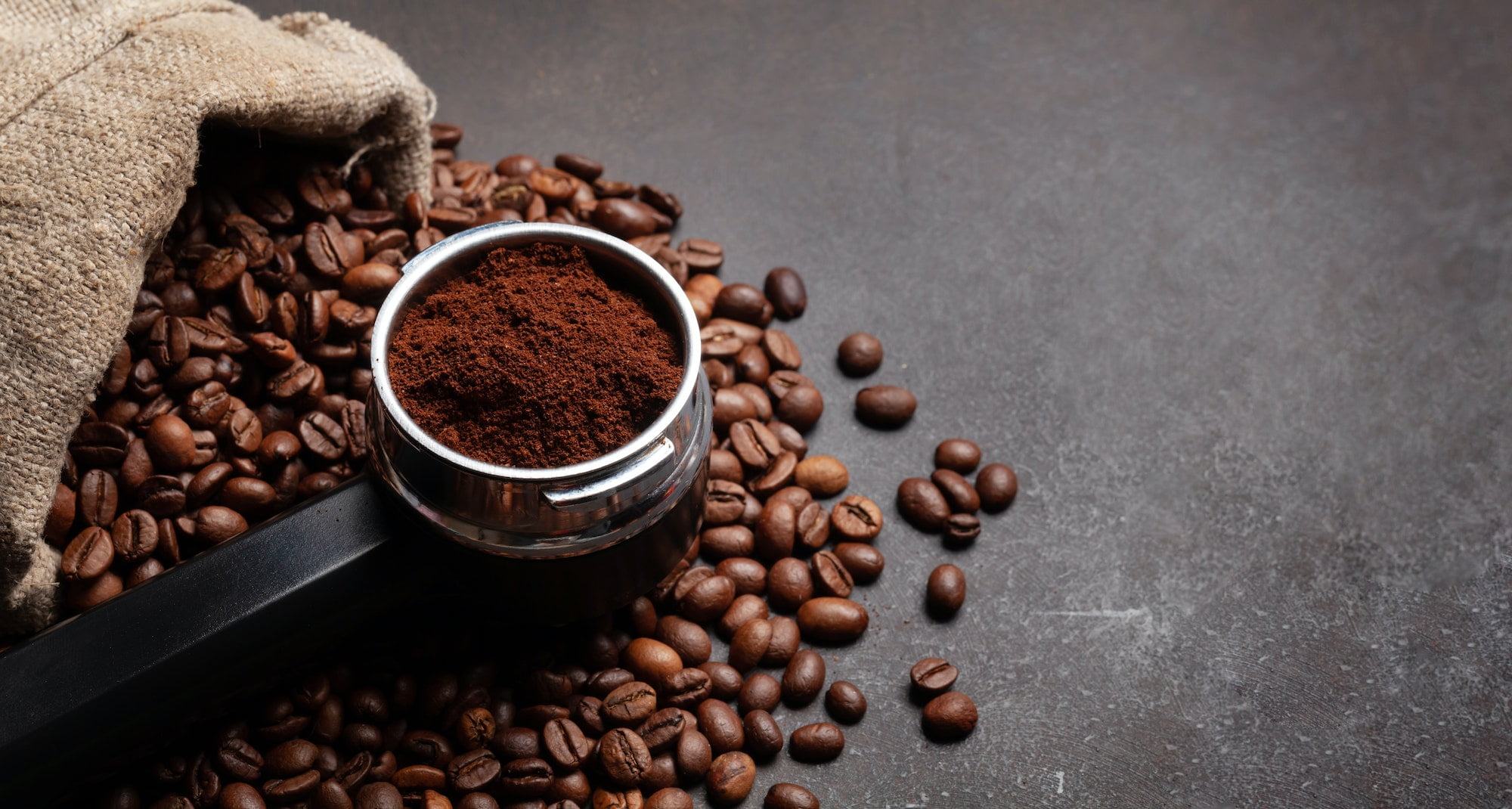 Roasted coffee beans and ground coffee in filter holder