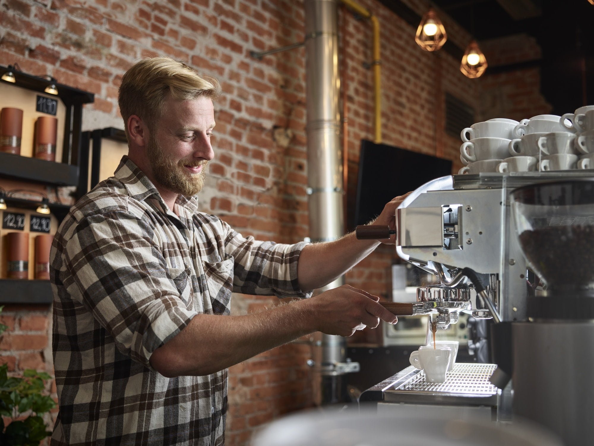 Man preparing espresso in a cafe